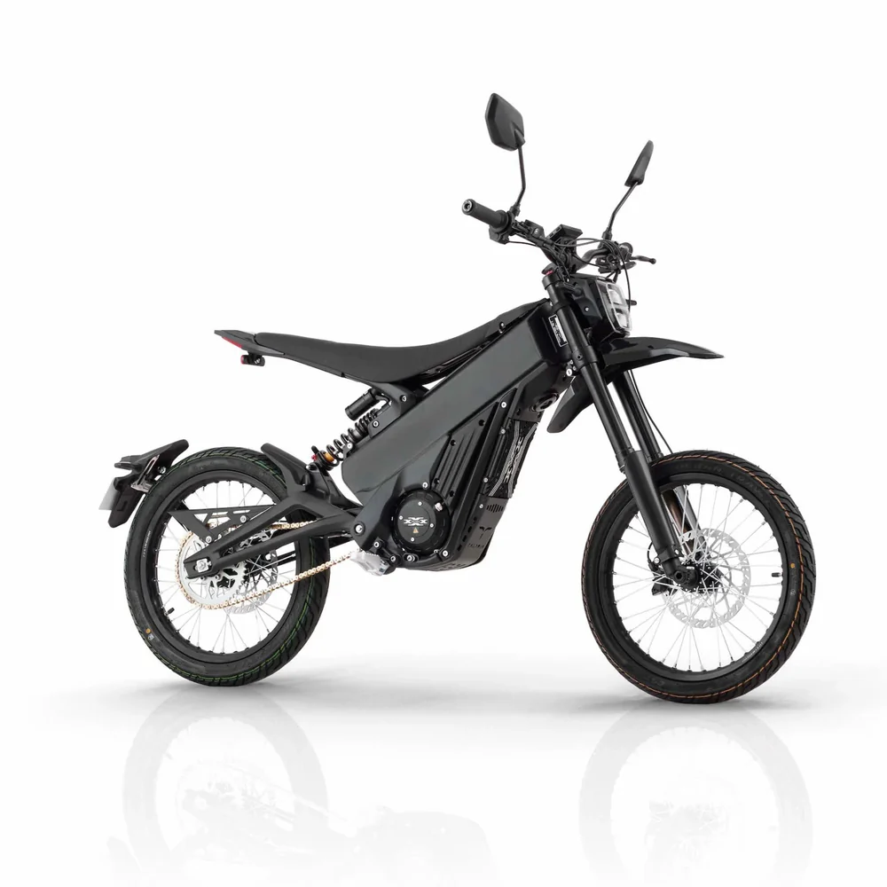 Talaria X3 Pro 5kw Electric Bike transitioning from urban street to a light off-road trail in Europe.