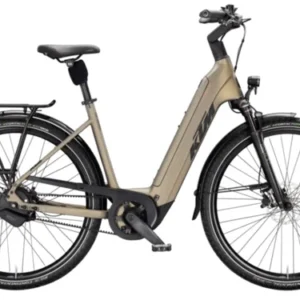 KTM MACINA CITY 810 BELT 2026 olive electric bike riding on a city street in Europe