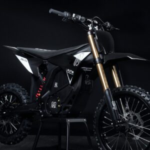 Altis Delta electric dirt bike performing a high jump on a rugged off-road trail in Europe.