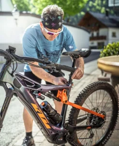KTM MACINA KAPOHO MASTER 43 cm '23 black electric mountain bike riding on a steep trail in Europe