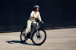 The 2025 Riese & Müller Homage5 GT Pinion HS electric bike in Dark Blue, featuring the revolutionary Pinion MGU (Motor Gearbox Unit), full suspension, Gates Carbon Belt Drive, 800Wh battery, and GX off-road package for high-speed European commuting and trekking.