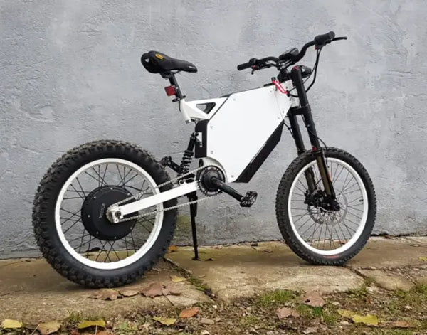 alaria X3 Pro 5kw Electric Bike transitioning from urban street to a light off-road trail in Europe.